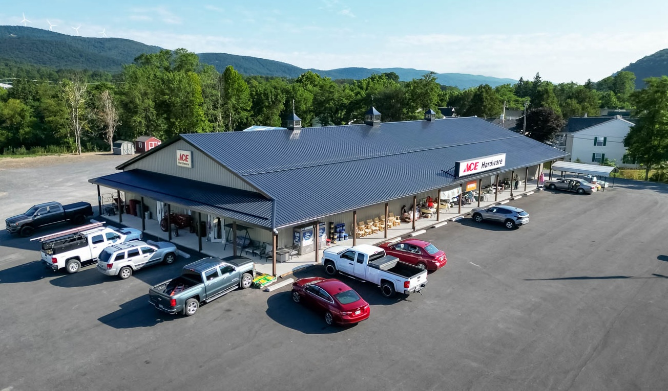 Ace Hardware with a shiny black G-Rib roof with clay siding