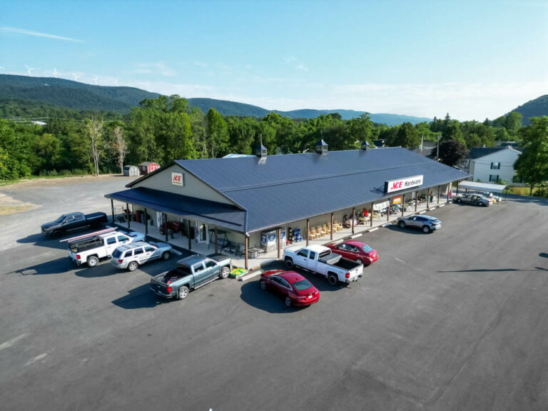 Ace Hardware with a shiny black G-Rib roof with clay siding