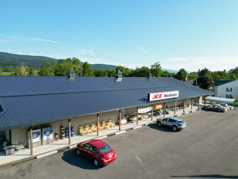 Ace Hardware with a shiny black G-Rib roof with clay siding