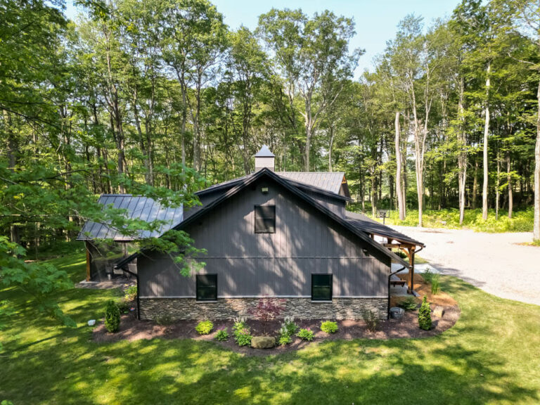 Side view of a house with a matte black standing seam roof