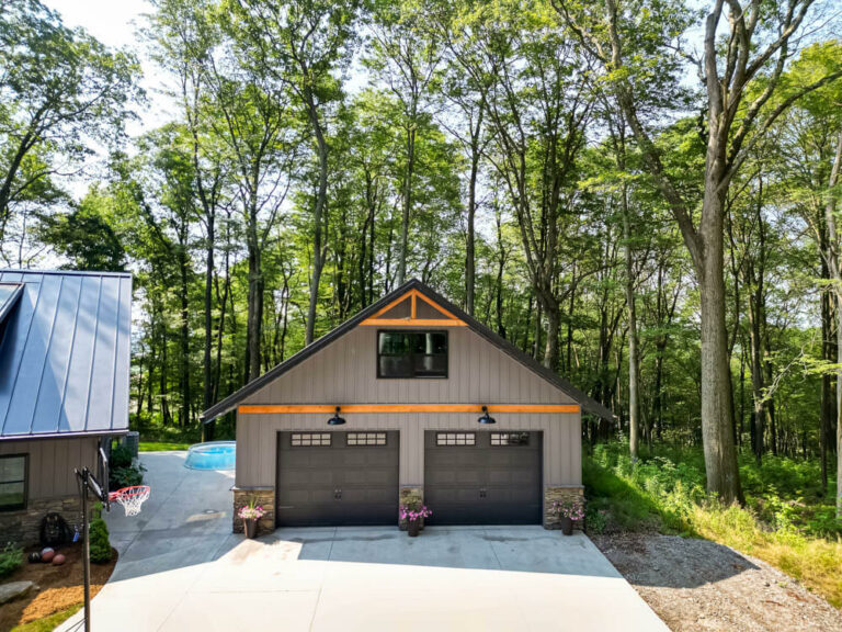 Garage on a house with a matte black standing seam roof